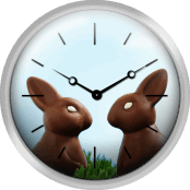 Two Chocolate Easter Bunnies Facing Each Other In Grass Side View